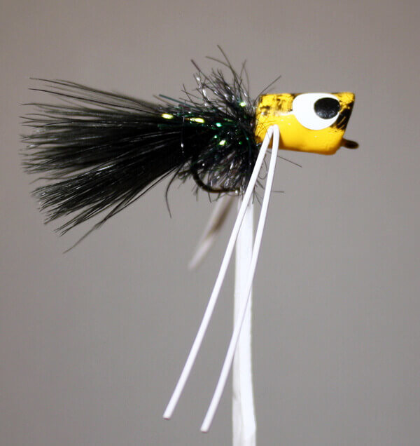 River Runt yellow body, black hackle, black tail, white rubber legs
