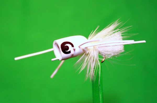 Bea's Popper #4 is all white, body, hackle, tail and rubber legs. The body is made in the USA from the root of the Tupelo tree. It has three red dots on its belly. Made in the USA.